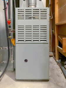 A gas furnace installed in a residential basement 